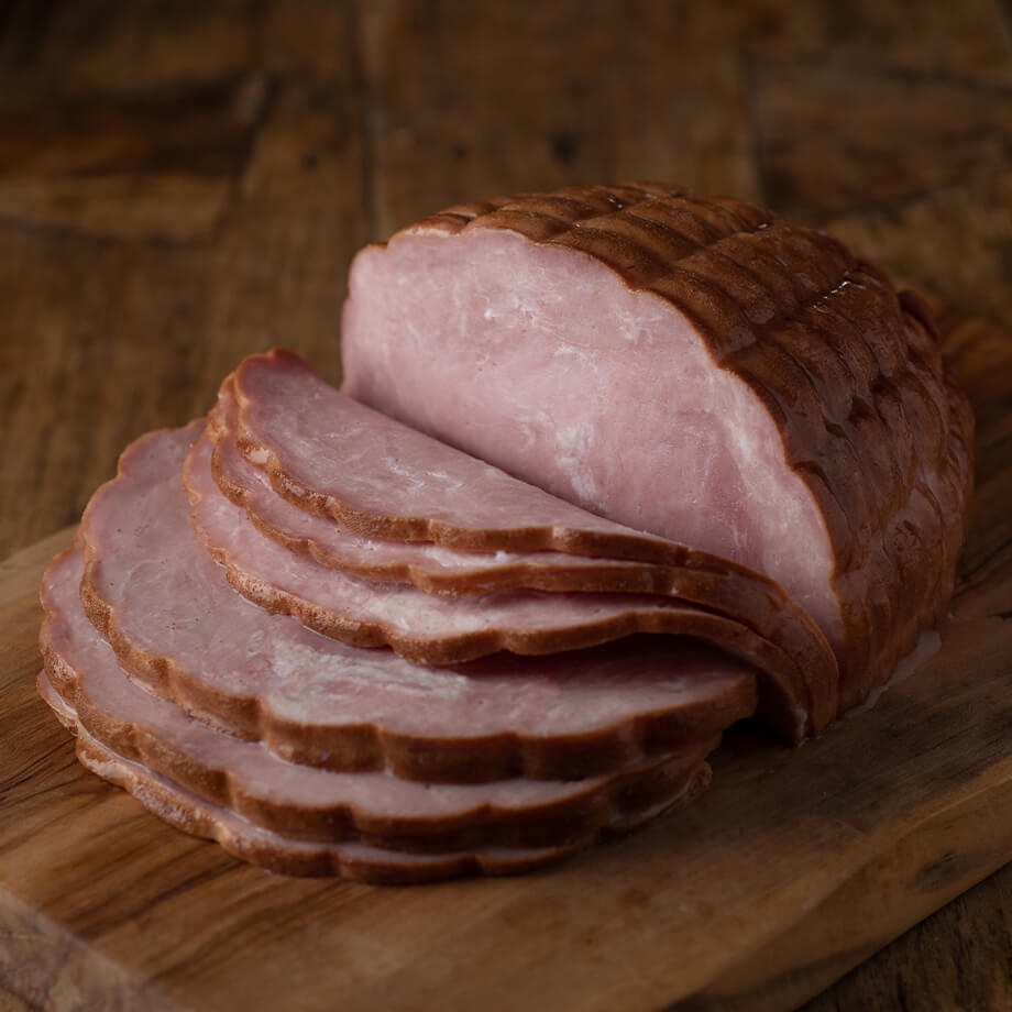 fresh sliced ham on a wood block