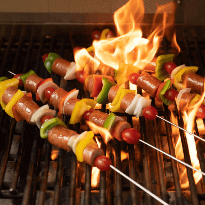 Kielbasa on the grill with a flame