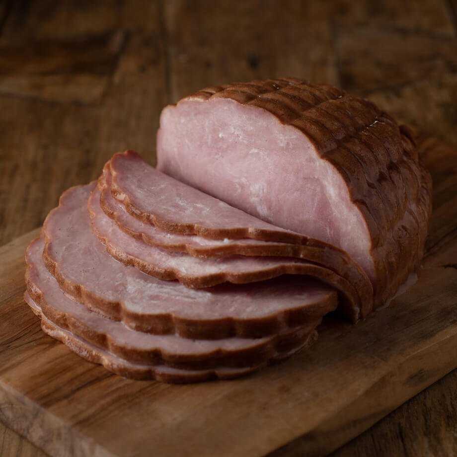 half ham sliced on wood block