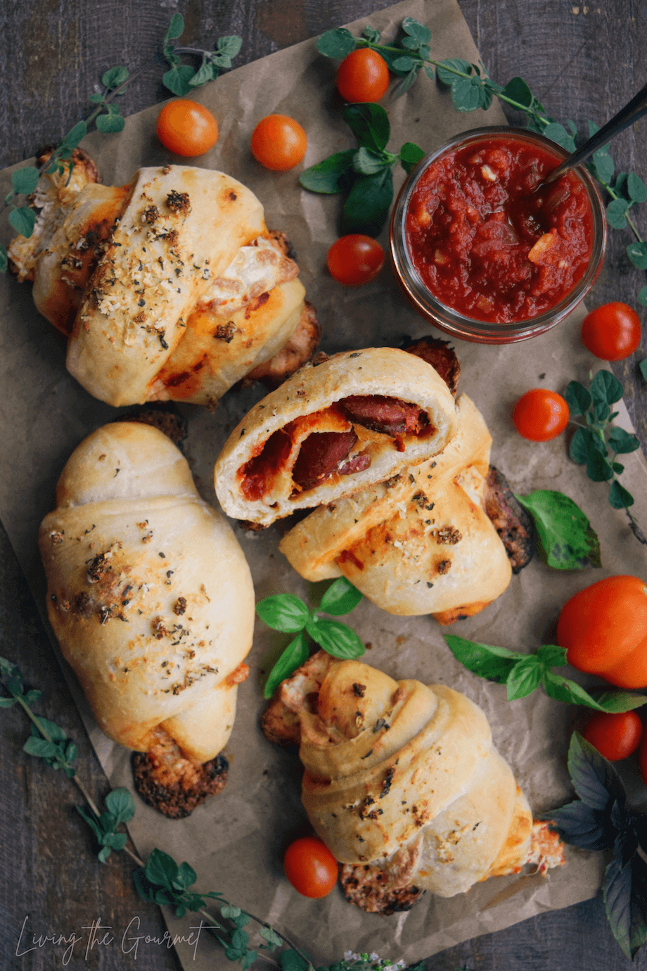 Pizza rolls with basil and sauce on a wooden table 