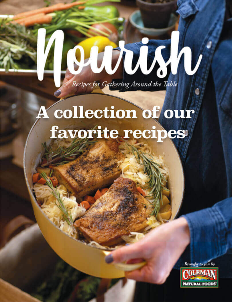 Nourish cookbook cover with a woman holding a dutch oven with pork and cabbage in it