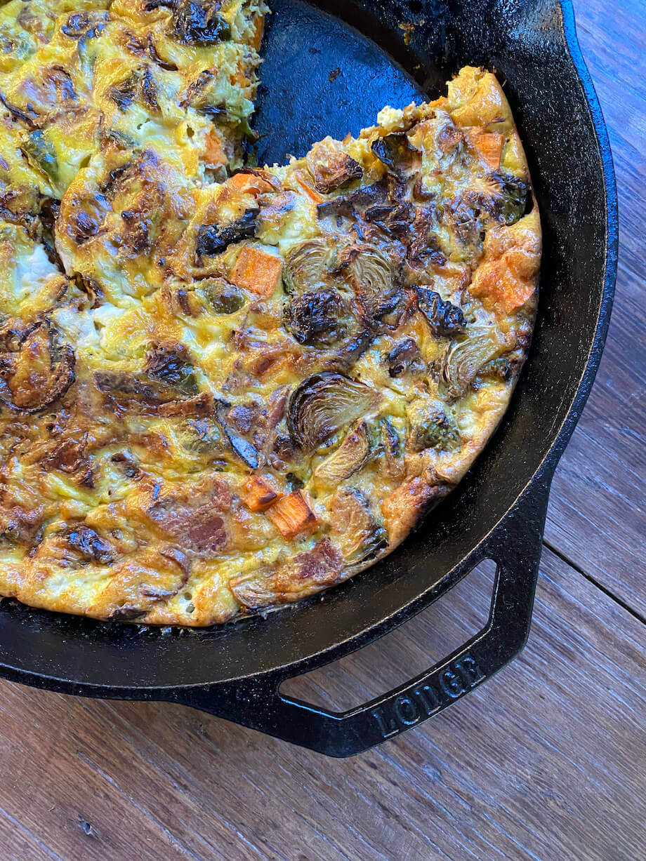 Bacon, Sweet Potato, and Brussel Sprouts Breakfast Casserole in a cast iron pan