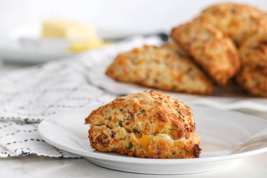 Bacon and cheddar cheese scones on a white plate
