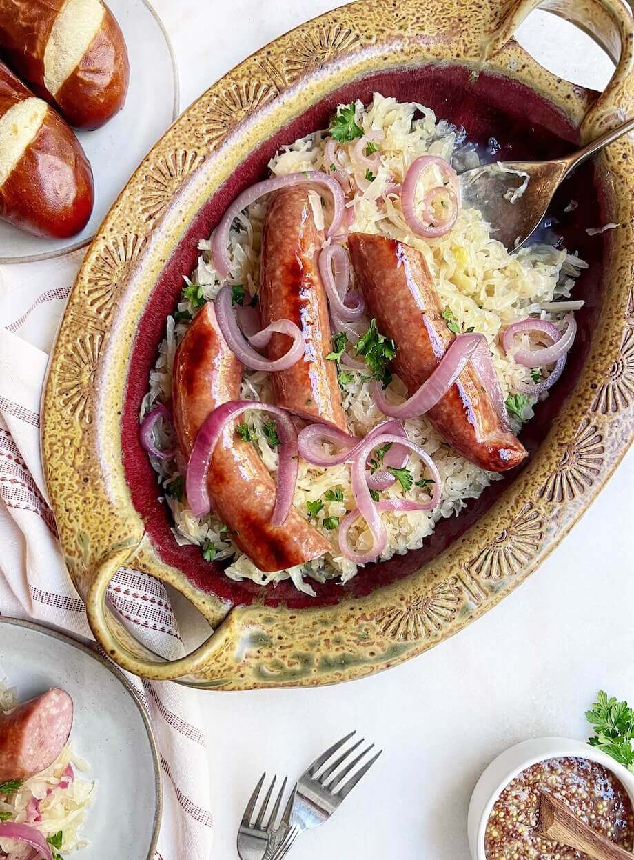 onions, sauerkraut, and Polish sausage in a tan dish