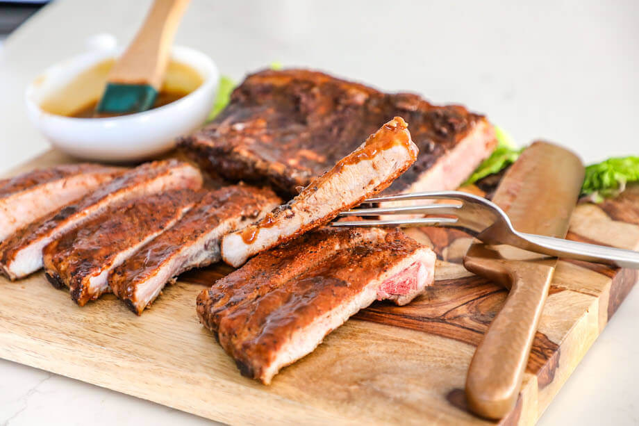 Ribs on a cutting board with a fork