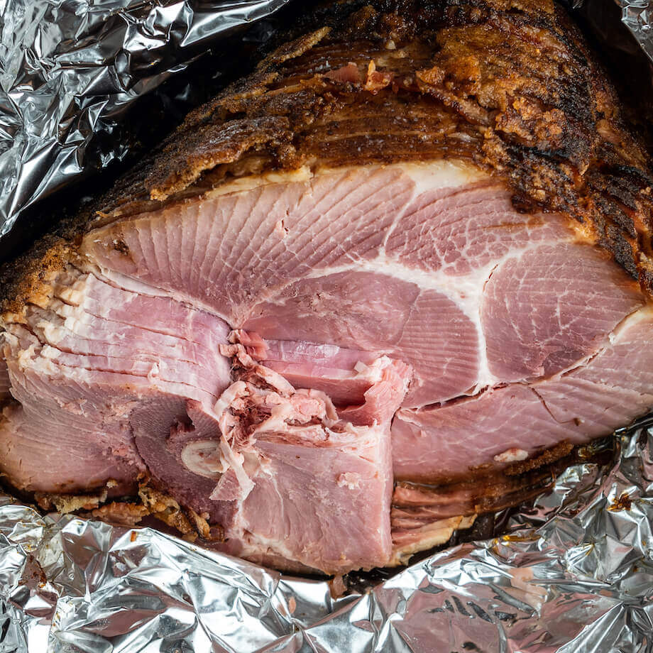 Cooked ham wrapped in foil